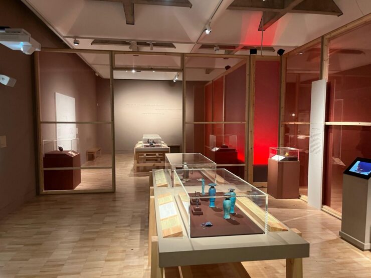 Picture of exhibition floor showing two small blue figurines made of glass.